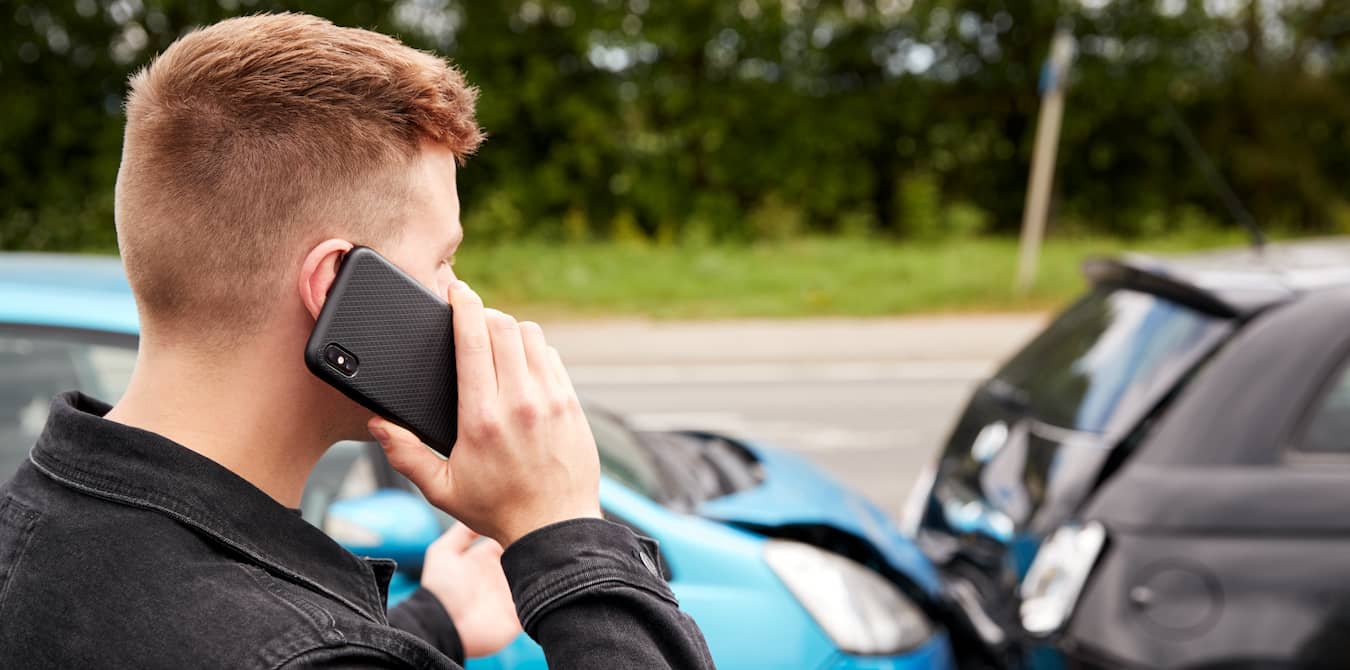 Man talking to car insurance company on the phone