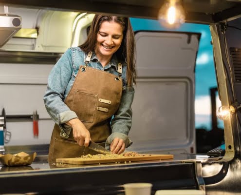 woman cooking food in a food truck