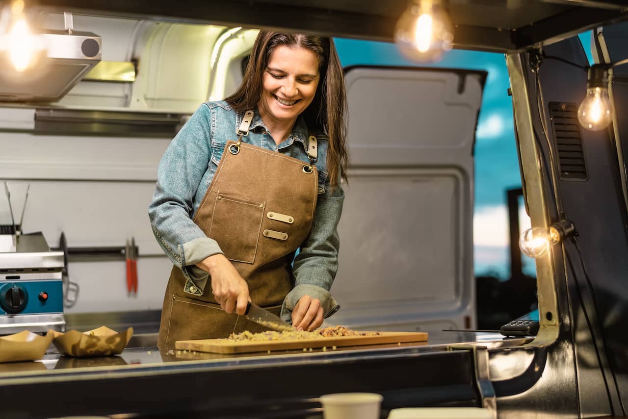 woman cooking food in a food truck