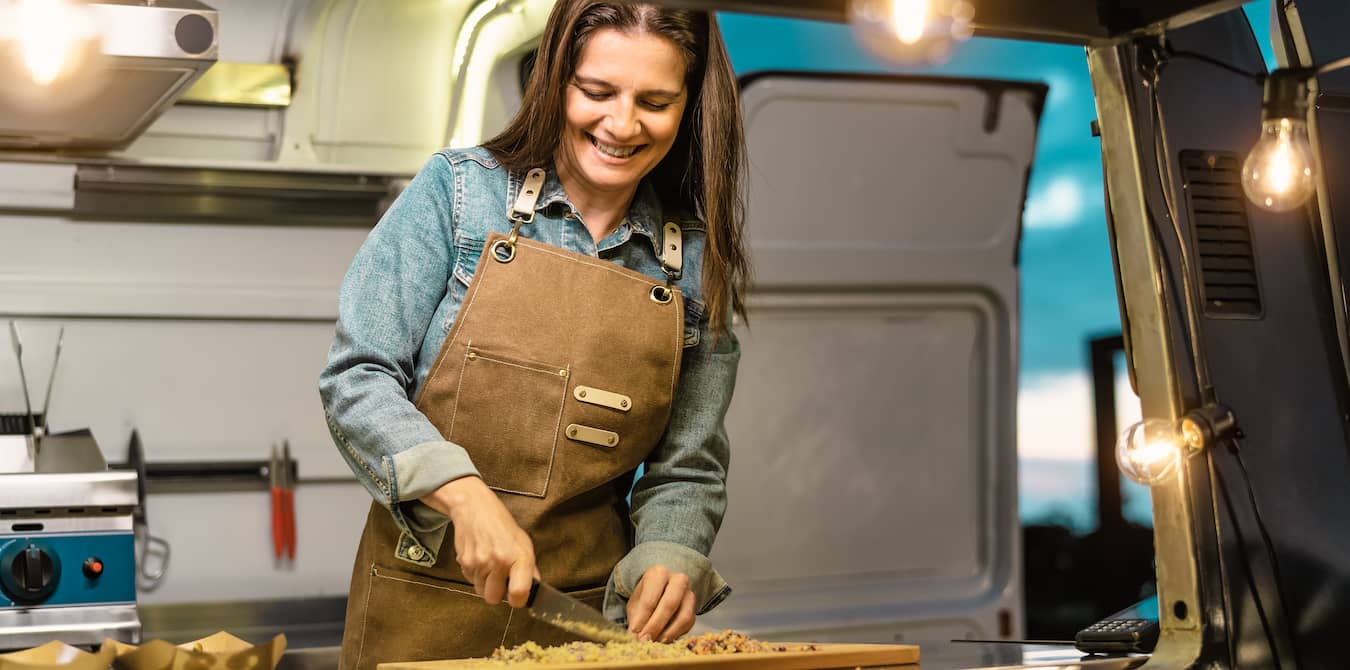 woman cooking food in a food truck