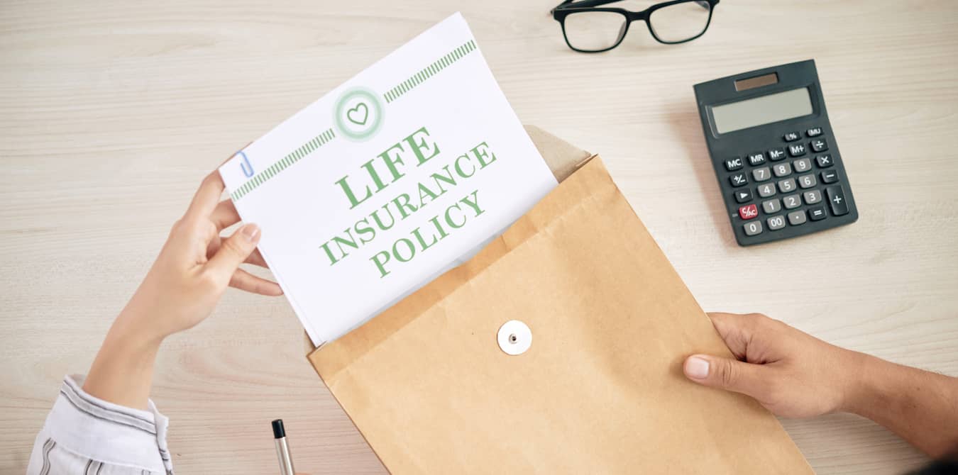 holding life insurance policy document in envelope